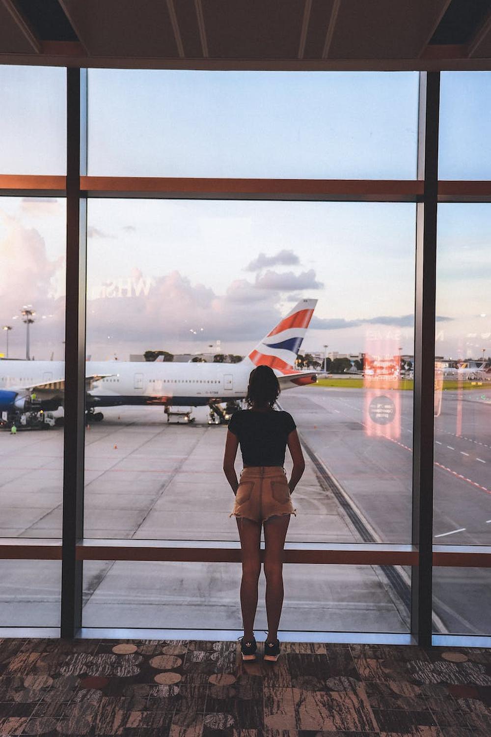 photo_of_woman_standing_near_glass_wall